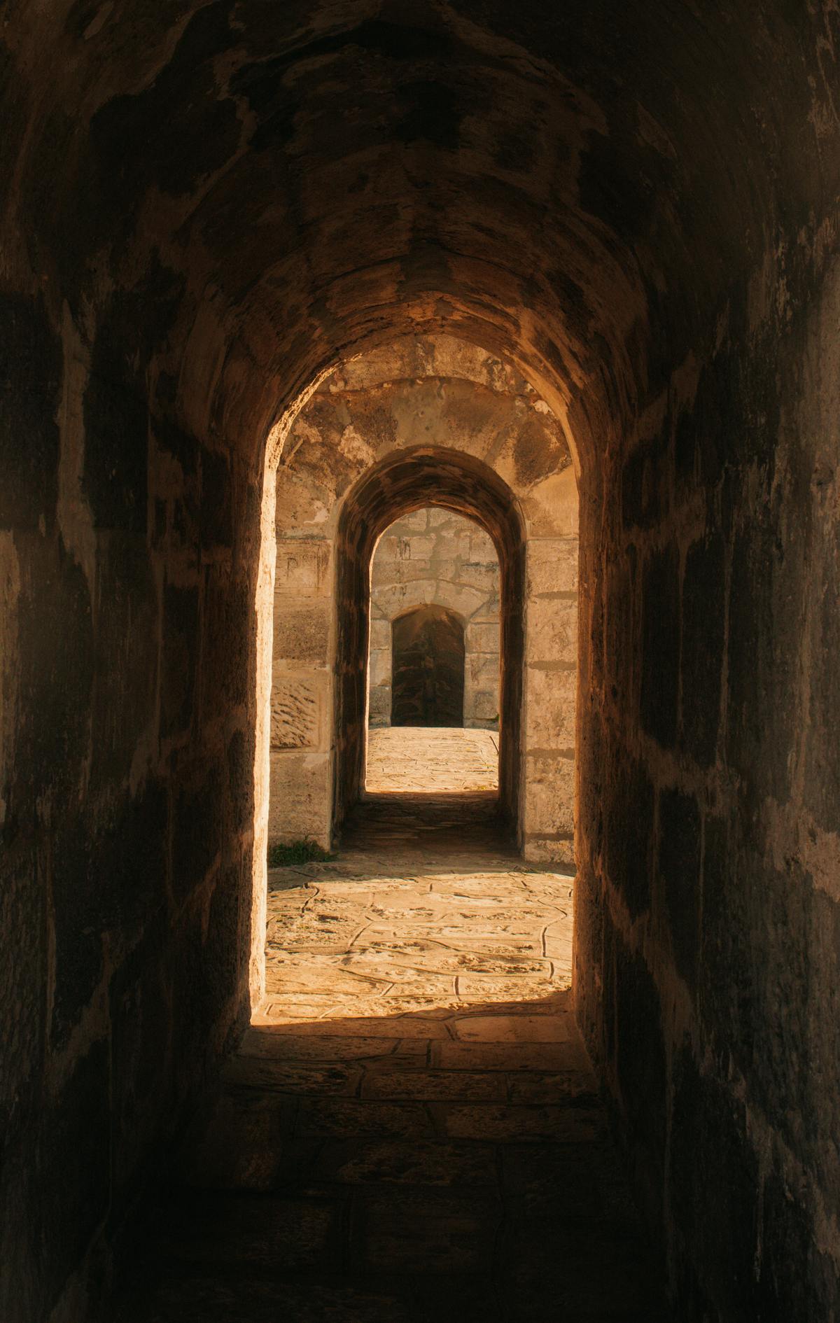 Narrow illuminated tunnel in the Napoli Sotterranea underground complex